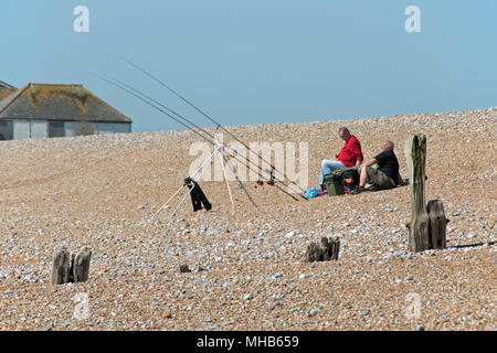 Pêche à la ligne de mer de la plage de la baie de Normands, Sussex, UKmen la pêche sur plage Banque D'Images
