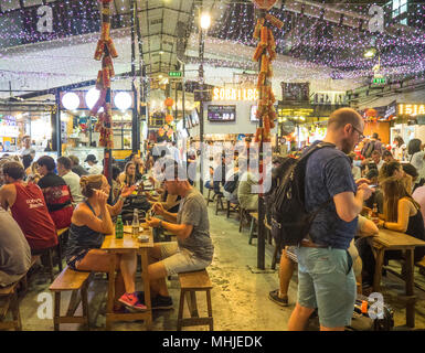 Les touristes de manger dans le marché alimentaire de la rue occupée, Ben Thanh, District 1 Ho Chi Minh City, Vietnam. Banque D'Images