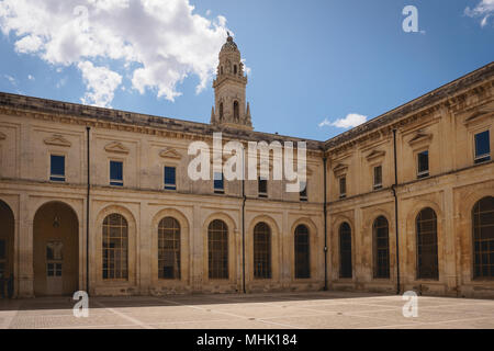 Lecce (Italie), août 2017. Vue sur le cloître du couvent des Théatins avec le clocher de la cathédrale en arrière-plan. Le format paysage. Banque D'Images