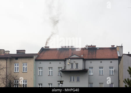 Oswiecim, Pologne - fumée noire sortant de la cheminée de l'immeuble, alors que le charbon-affectueux Pologne lutte avec killer le smog. La pollution de l'air. Banque D'Images