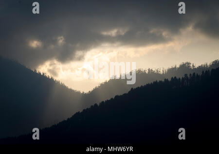 Soleil qui brille à travers les nuages, plus de chaînes de montagnes, la vallée de Phobjikha, Wangdue Phodrang, Bhoutan Banque D'Images