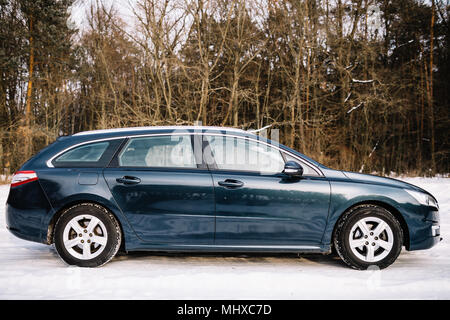 Voiture bleue sans une marque de commerce sur route d'hiver. Banque D'Images