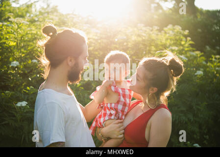 Couple avec bébé girl in garden Banque D'Images