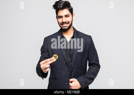 L'homme indien d'or tenant en main des bitcoins isolé sur fond blanc Banque D'Images