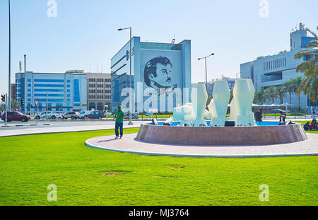 DOHA, QATAR - février 13, 2018 : le portrait de l'Emir du Qatar - Tamim la glorieuse sur le mur du bâtiment derrière le pot d'eau Monument sur Corniche pro Banque D'Images