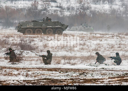Un bulgare BTR-60 véhicule de transport de troupes et les soldats affectés à la 42e Bataillon d'infanterie mécanisée, Yambol, Bulgarie, la configuration d'un périmètre de défense autour de l'un des principaux objectifs de formation partenariat avec point au cours des soldats américains affectés à la Compagnie B, 1er Bataillon, 18e Régiment d'infanterie, 2e Brigade blindée, l'équipe de combat de la 1ère Division d'infanterie, de Fort Riley, Kansas, à la zone d'entraînement Novo Selo, Bulgarie, le 23 mars 2018. Les deux forces alliées ont participé à deux jours de formation conjointe exercer sous le commandement et le contrôle des lieutenant-colonel Bulgare Ivaylo Ivanov, commandant de bataillon de la 4 Banque D'Images