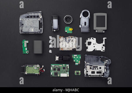 Les parties d'une mini caméra vidéo DV et bien séparés sur fond noir, vue ci-dessus. Banque D'Images