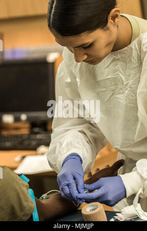 La CPS. Tracy Ortiz, troupe 7417th clinique médicale, attire le sang pendant le traitement de l'état de préparation militaire à Fort Belvoir Community Hospital, 10 décembre 2017. C'est la première fois qu'une réserve de l'Armée de l'unité de soutien médical a été en mesure d'améliorer directement prêt à la fois actif et des soldats de la réserve dans la ville capitale de la région. La troupe 7417th Clinique médicale est l'une des nombreuses unités relevant de la réserve de l'Armée de terre commande médicale. ARMEDCOM fournit un soutien à la mobilisation et le déploiement des installations de traitement militaire active et éventualités tout en fournissant des soins de santé sous-financé avec les collectivités Banque D'Images