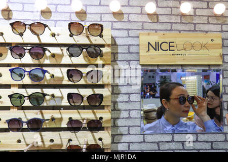 Wenzhou, province de Zhejiang en Chine. 5 mai, 2018. Une femme essaie une paire de lunettes de soleil au cours de la 16e int'l Wenzhou Optics Fair dans la ville de Wenzhou, province de Zhejiang en Chine de l'Est, le 5 mai 2018. Les 3 jours ouvert juste ici le samedi, attirant plus de 550 exposants. Qiaojiang Crédit : Su/Xinhua/Alamy Live News Banque D'Images