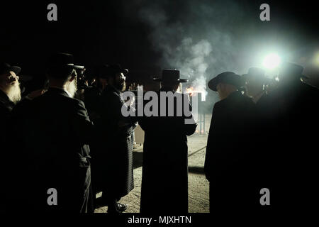 Les hommes juifs ultra-orthodoxes de la dynastie hassidique Shomrei Emounim danse comme ils allument un feu d'huile géant dans le quartier religieux Geula lors de la fête de Lag BaOmer qui marque la célébration, interprétée par certains comme l'anniversaire de la mort de Rabbi Shimon Bar Yochai, un des grands sages du judaïsme, il y a quelque 1800 ans et le jour où il a révélé les secrets de la kabbale un texte historique de la mystique juive Banque D'Images