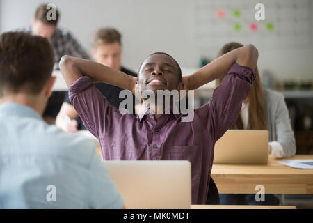 Happy african american leaning in Chair in office Banque D'Images