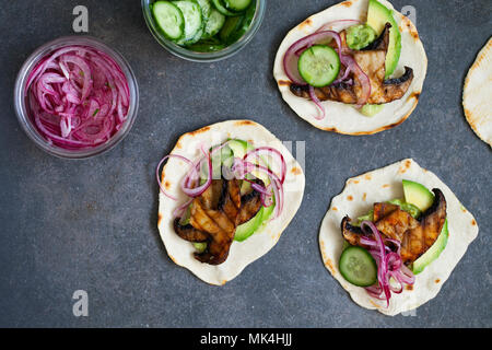 Tortillas vegan avec champignons, avocat, oignons marinés et concombre Banque D'Images