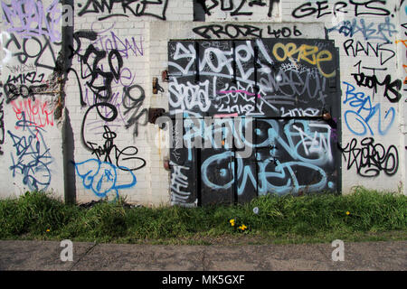 Porte fermée et verrouillée sur le halage du canal de Londres, couverte de graffiti tag Banque D'Images