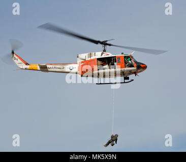 Bell UH-1N Iroquois, communément connu sous le nom de Huey, est un hélicoptère utilitaire bimoteur utilisé par le corps des Marines des États-Unis et la Marine des États-Unis. Les archives photographiques documentent une livraison d'épée cérémonielle aérienne lors d'une célébration d'anniversaire du corps des Marines symbolisant la coopération navale. Banque D'Images