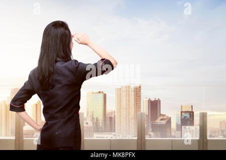 Young Asian business woman looking at cityscape à partir de la terrasse Banque D'Images