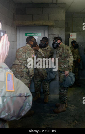 Des soldats américains avec 650e Groupe de renseignement militaire vérifiez les filtres de leurs M50 Service Commun masque à usage général, à mesure qu'ils renforcent la confiance, dans le centre de support de formation chimique, biologique, radiologique et nucléaire du Benelux, dans la chambre d'Chièvres, Belgique, novembre 09, 2017. (U.S. Photo de l'armée par Visual Spécialiste de l'information, Pierre-Etienne Courtejoie) Banque D'Images