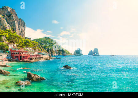 Avis de faraglioni au coucher du soleil à partir de la plage de Marina Piccola sur journée d'été avec des eaux bleu turquoise et des cafés en bord de mer, Capri, Italie Banque D'Images