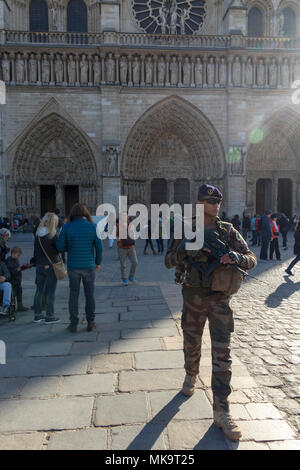 Soldat de l'armée française patrouille à côté de touristes en face de Notre Dame de Paris, France Banque D'Images