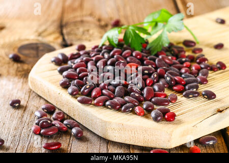 Haricots verts crus rouge avec sur une table en bois Banque D'Images