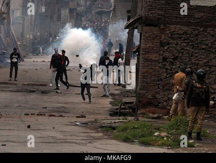 Le cachemire. 7 mai, 2018. Comme la fumée monte lacrymogènes les manifestants du Cachemire en conflit avec la police indienne de Srinagar, la capitale d'été du Cachemire sous contrôle indien, 07 mai 2018. La police a tiré des gaz lacrymogènes, granulés de bois et des grenades assourdissantes pour disperser la foule en colère.anti-massive des affrontements éclatent à Srinagar Inde suite à l'assassinat de dix personnes dont cinq rebelles et cinq civils par les forces de sécurité indiennes en Afrique du Cachemire. Credit : Faisal Khan/ZUMA/Alamy Fil Live News Banque D'Images