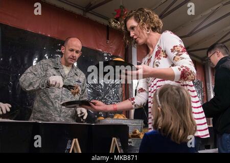 Le colonel E. John Teichert, Joint Base Andrews et 11e commandant de l'Escadre, sert de la nourriture à une famille de militaires au cours de la 11e cérémonie des lumières des fêtes à JBA, Md., le 30 novembre 2017. L'arbre éclairage fourni la base avec l'occasion de célébrer les fêtes et à prendre un moment pour rappeler les membres de service déployées pendant les vacances. (U.S. Air Force photo par un membre de la 1re classe Valentina Lopez) Banque D'Images