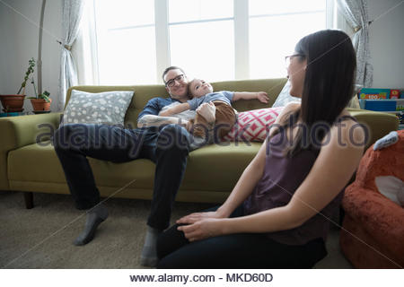 Young family relaxing in living room