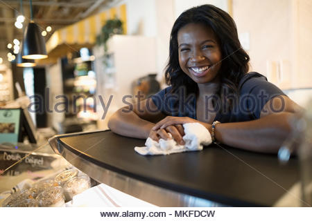 Portrait femme heureux propriétaire de petite entreprise travailler derrière comptoir café