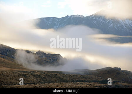 Les rouleaux en brouillard sur les contreforts des Alpes du Sud dans la région de Canterbury, île du Sud, Nouvelle-Zélande Banque D'Images