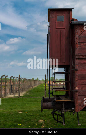 Détails de lonely train wagon dans Auschwitz II Birkenau, camp de concentration nazi en Pologne. Les barbelés et les bâtiments en arrière-plan. Banque D'Images