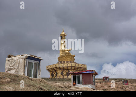 La méditation religieuse tibétaine hut et gourou Rimpoche statue, Yarchen Gar, Sichuan, Chine Banque D'Images