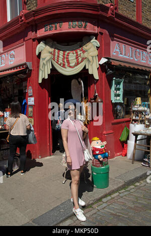 Alices célèbre antiquaire sur marché de Portobello Road à Notting Hill, à l'ouest de Londres, Angleterre, Royaume-Uni. Les personnes bénéficiant d'une journée ensoleillée à traîner dans le célèbre marché de dimanche, lorsque la ligne des stands d'antiquités de la rue. Portobello Market est le plus grand marché d'antiquités avec plus de 1 000 distributeurs de vendre tout type de meubles anciens et de collection. Visiteurs viennent du monde entier pour marcher le long d'une des rues de Londres Best Loved. Banque D'Images