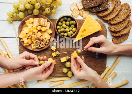 Les femmes qui effectuent des canapés avec du fromage Banque D'Images