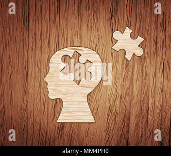 Tête de puzzle concept du cerveau. Profil de tête humaine faite de papier brun avec un jigsaw piece cut out. Banque D'Images