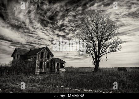 Photo en noir et blanc d'une vieille ferme abandonnée c'est effrayant de se détériorer avec le temps et la négligence. Banque D'Images