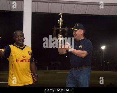 171009-N-RD713-546 SASEBO, Japon (oct. 9, 2017) Le capitaine Larry McCullen, droite, commandant du navire d'assaut amphibie USS Bonhomme Richard (DG 6), remet un trophée à mate du machiniste 1re classe Sallyvidia Isiaho, entraîneur de l'équipe de soccer du navire, à la suite d'un match entre le Bonhomme Richard marins et de la Royal Australian Navy (RAN) marins affectés à la frégate de classe ANZAC HMAS Parramatta (FFH 154). Le tournoi de soccer, qui a eu lieu au cours de l'horaire de Parramatta escale au port de Sasebo, Japon, a souligné l'esprit de camaraderie et de relation de longue date entre la Marine américaine et courut. Bonhomme Richa Banque D'Images