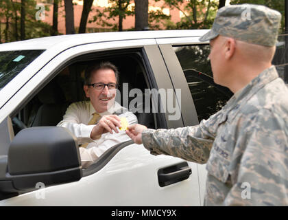 Michael Boudreau, 66e Escadron de soutien de la Force et des exercices d'Inspections, chef accepte la prévention du suicide du colonel matériel Roman L. Hund, commandant de l'installation, comme il arrive pour travailler à Hanscom Air Force Base, Mass., 6 septembre. Hund et le commandement de Hanscom Chef, Chef Master Sgt. Henry L. Hayes, a remis les cartes de membres de la main-d'œuvre dans le cadre du Mois de la prévention du suicide. (U.S. Air Force photo par Linda Labonté Britt) Banque D'Images