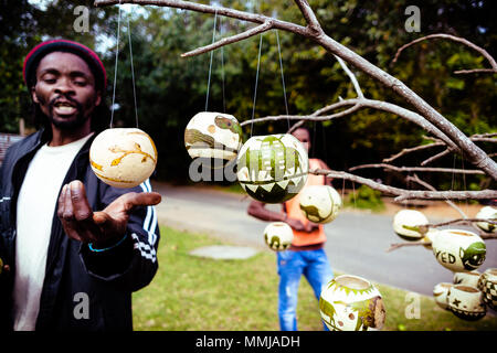 L'homme d'Afrique noire locale traditionnelle vente Hand-Carved Coco Boutique Souvenirs / Bibelots sur arbre - KwaZulu Natal, Afrique du Sud Banque D'Images