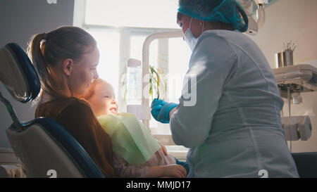 Petite fille à la réception chez le dentiste, le nettoyage et l'arrosage stomatologist les dents de l'enfant, girl smiling Banque D'Images