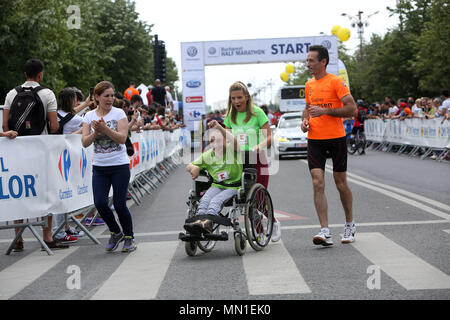 Bucarest, Roumanie. 13 mai, 2018. Une fille en fauteuil roulant prend part à une course populaire au Semi-marathon de Bucarest à Bucarest, Roumanie, le 13 mai 2018. Crédit : Gabriel Petrescu/Xinhua/Alamy Live News Banque D'Images