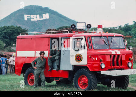 Managua, Nicaragua, juin 1986, l'usine les travailleurs qui font la formation de lutte contre l'incendie avec la ville de pompiers. Banque D'Images