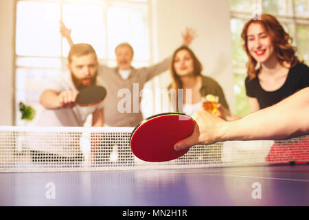 Groupe de professionnels jeunes amis jouer au ping-pong tennis de table Banque D'Images