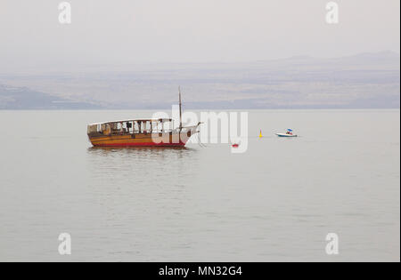 Le calme des eaux miroitantes de la mer de Galilée avec bateaux amarrés en début de soirée sur un jour brumeux en mai 2018 Banque D'Images