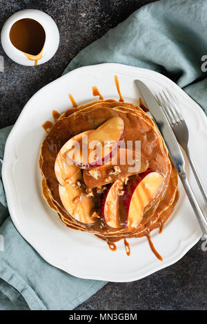 Crêpes aux pommes caramélisées et sauce au caramel, table vue d'en haut. Concept alimentaire d'automne Banque D'Images