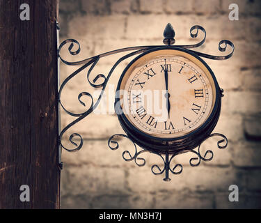 Vintage horloge de la rue sur un poteau en bois Banque D'Images