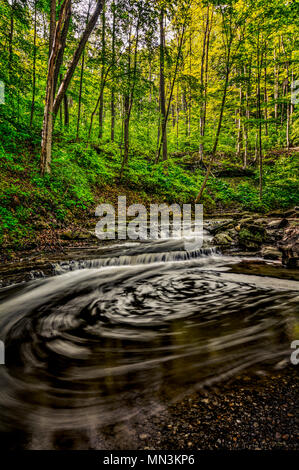 Une petite cascade en aval de Blue Hen Falls de Cuyahoga Valley National Park dans l'Ohio. Le tourbillon de l'eau constitue un modèle circulaire. Banque D'Images