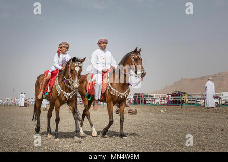 Ibri, Oman, le 28 avril 2018 : père omanais et son riding chevaux arabes Banque D'Images