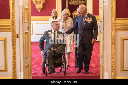 Le Major Peter Norton GC, qui a perdu un bras et une jambe tout en dirigeant une équipe de neutralisation en Iraq en 2005, avec le Prince de Galles et la duchesse de Cornouailles lors d'un tea party à Clarence House de Londres pour les membres de la Croix de Victoria et George Cross Association. Banque D'Images