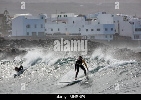 LANZAROTE, îles Canaries, Espagne : attraper les surfeurs vagues devant le village La Santa. Banque D'Images