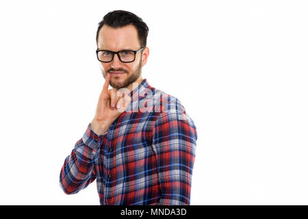 Portrait de jeune homme au petit doigt sur la bouche Banque D'Images