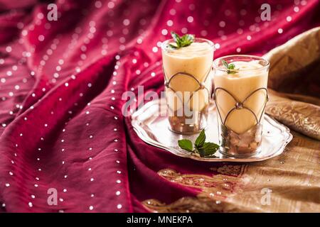 Lassi à la mangue dans deux verres sur un plateau (Inde) Banque D'Images